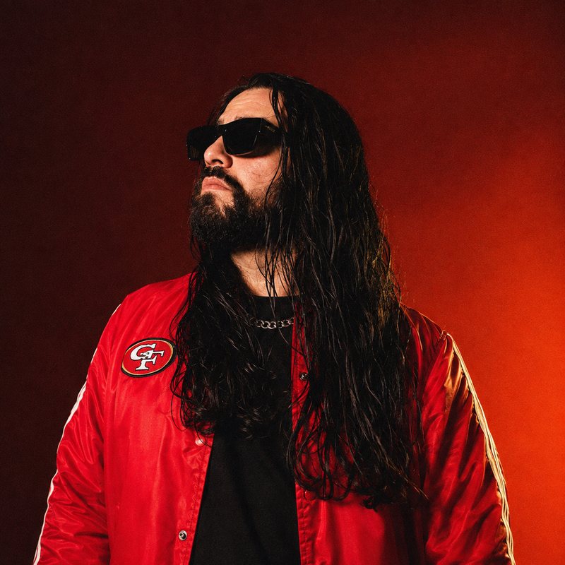 Victor Goshfather Tapia wearing black sunglasses and a red jacket